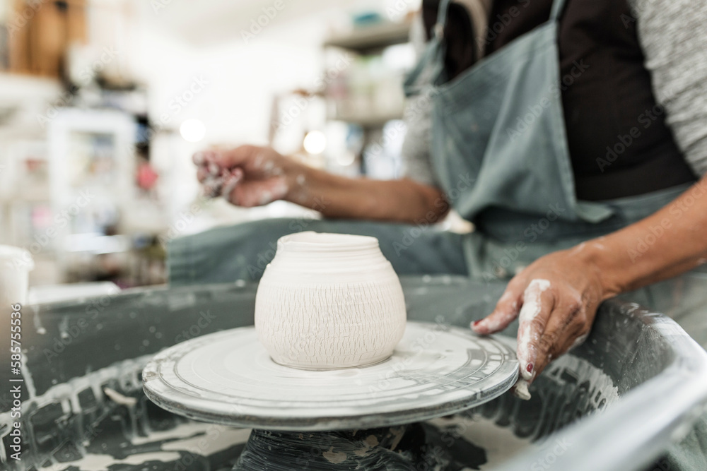 Mid section of woman making pottery Mid section of woman making pottery