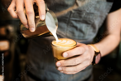 Mid section of barista preparing coffee photo