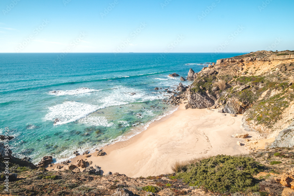 Breathtaking cliffs surround the sandy beach of Praia da Angra da Cerva on the Atlantic coast near Vila Nova de Milfontes, Odemira, Portugal. In the footsteps of Rota Vicentina. Fisherman trail