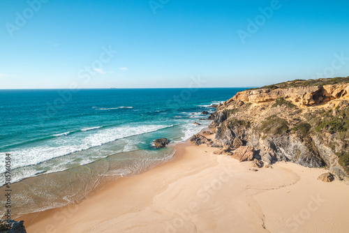 Breathtaking cliffs surround the sandy beach of Praia da Angra da Cerva on the Atlantic coast near Vila Nova de Milfontes  Odemira  Portugal. In the footsteps of Rota Vicentina. Fisherman trail