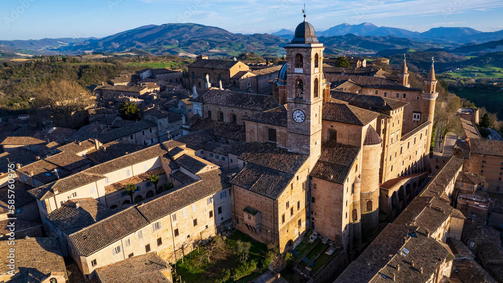 Obraz premium One of the most beautiful medieval towns of Italy - Urbino in Marche region. aerial drone panoramic high angle view over sunset