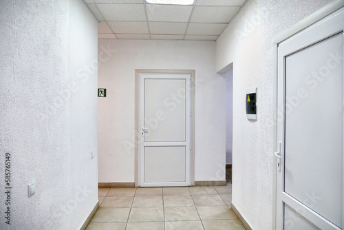 Wallpaper Mural Corridor with white walls, white plastic doors and communications. Torontodigital.ca
