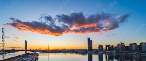 Silhouettes of city buildings in Melbourne's docklands at sunset photo