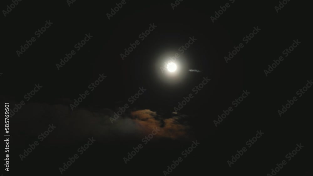 Time lapse of the moon in a dark sky through black clouds. Moon light through the clouds on dark night sky show beautiful texture on nature landscape Time lapse of the moon in a dark sky through black clouds. Moon light through the clouds on dark night sky show beautiful texture on nature landscape