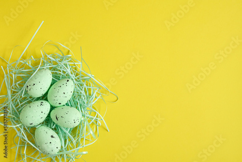 Easter eggs on a yellow background. Space for text, banner. Top view.