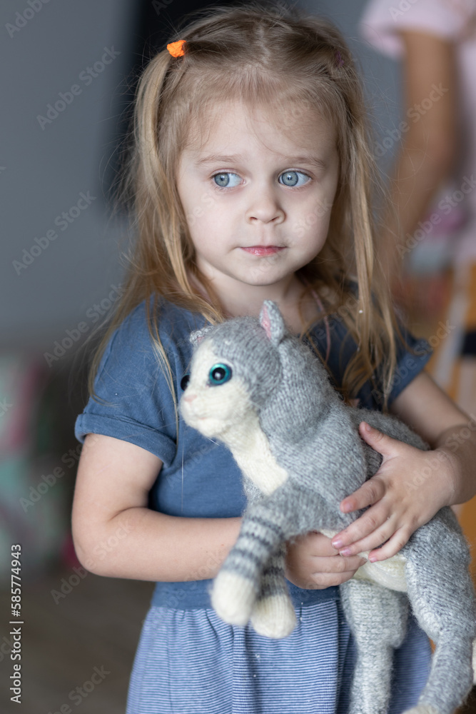 A baby girl with a cat toy A baby girl with a cat toy