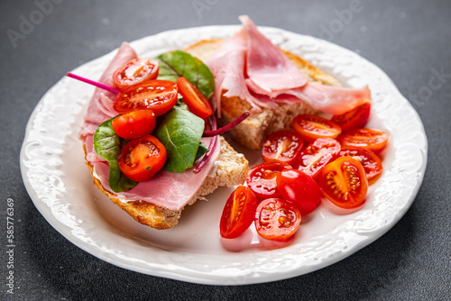 sandwich ham, tomato, lettuce bruschetta snack ready to eat healthy meal food snack on the table copy space food background rustic top view