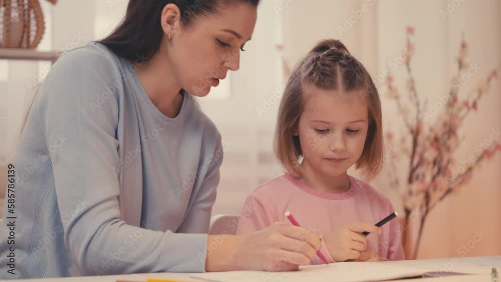 Smiling parent and little girl drawing together at home, happy childhood, diy Smiling parent and little girl drawing together at home, happy childhood, diy
