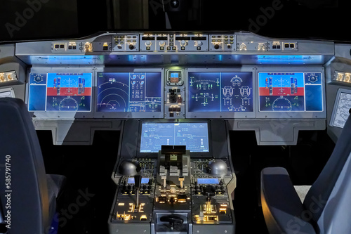 Modern dashboard with controls in the pilot cockpit of a passenger aircraft.