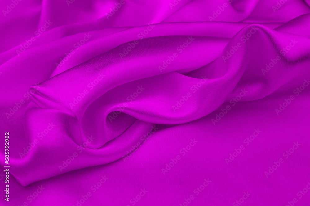 Obraz premium Satin beautiful silk fabric in lilac color lies with drapery. 