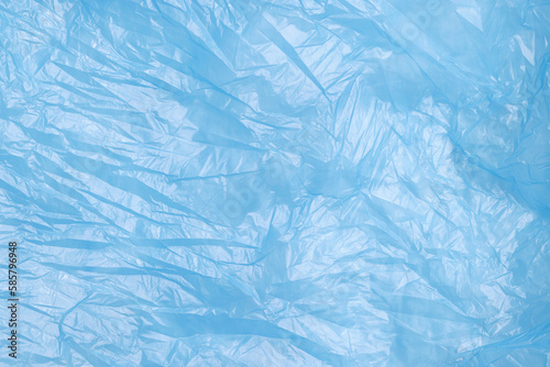 Crumpled light blue plastic bag as background, top view