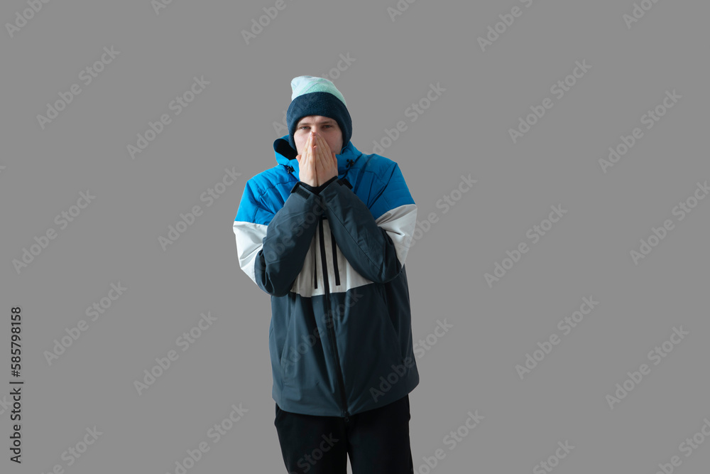 young male guy wearing warm winter season jacket on a cold day