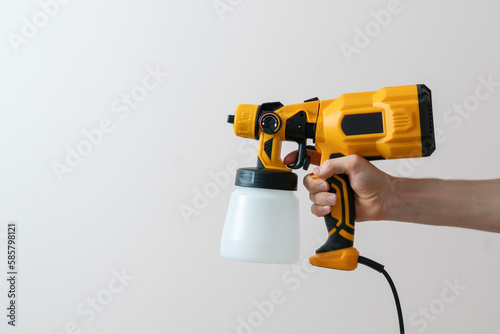 the isolated hand holding a spray paint gun, template mockup