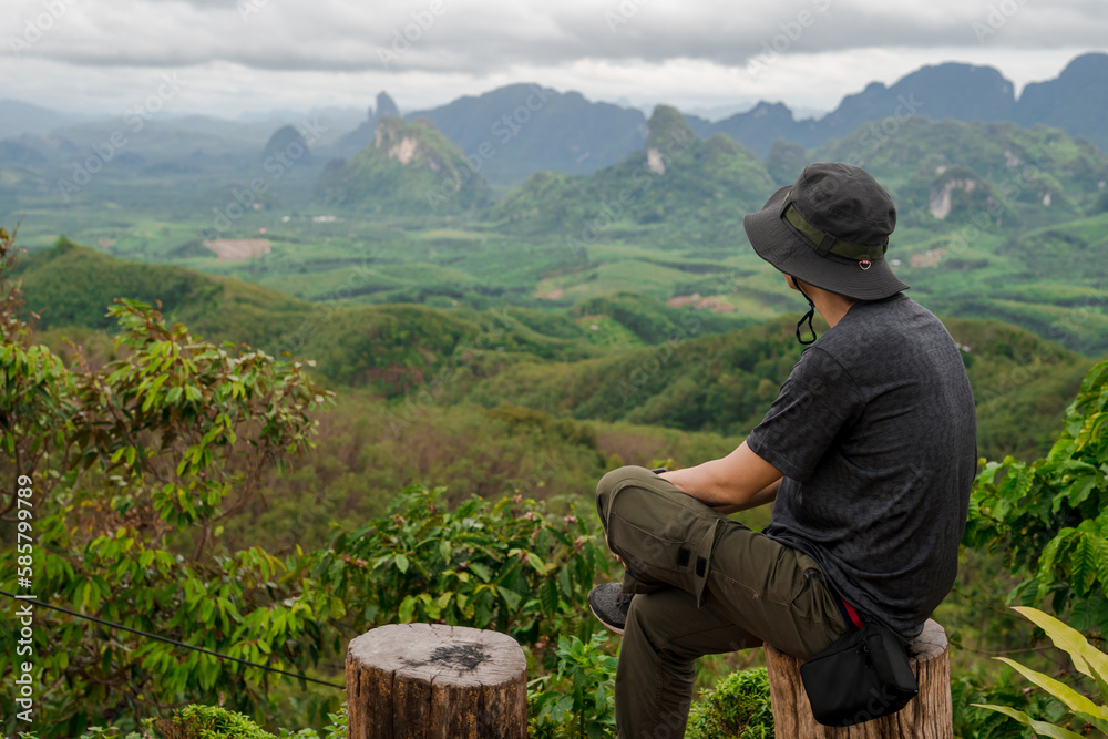 man relax after hiking to top of mountain in raining season travel man relax after hiking to top of mountain in raining season travel