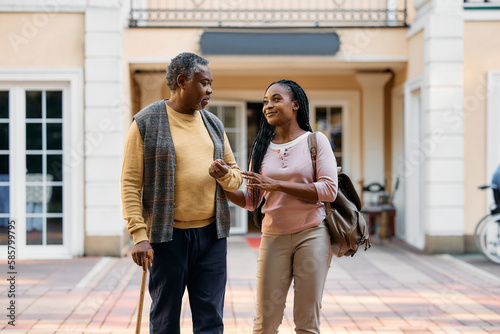 Billede på lærred Happy black woman talks to her senior father while vising him in residential care home