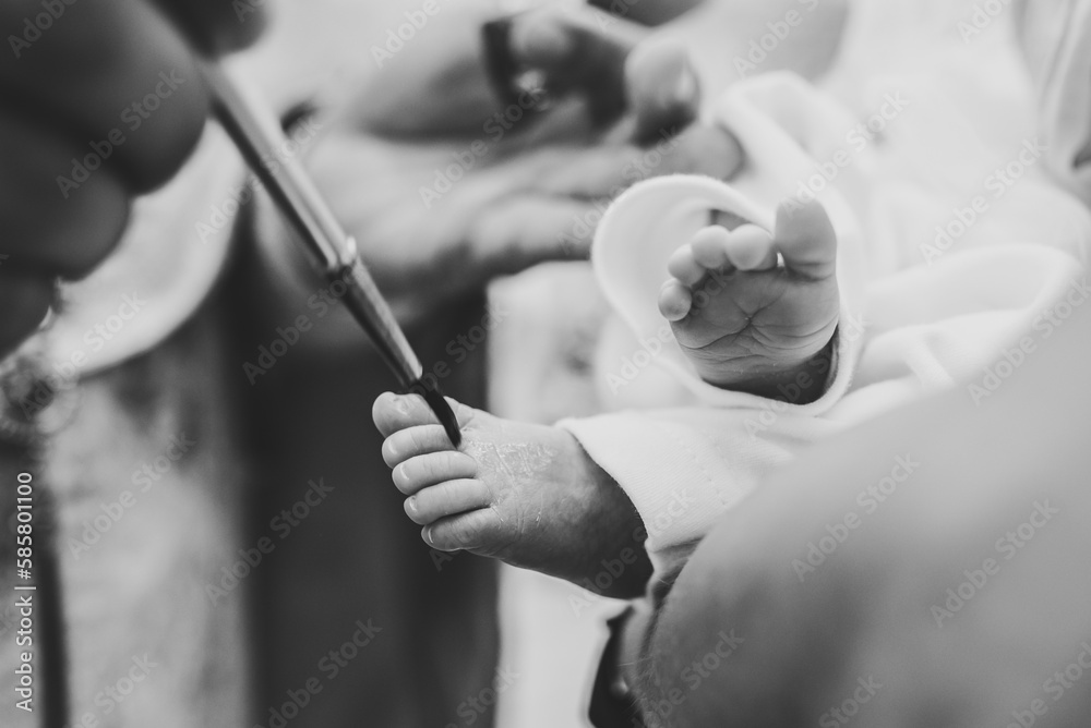 Baptism ceremony of a baby. Close up of tiny baby feet, the sacrament