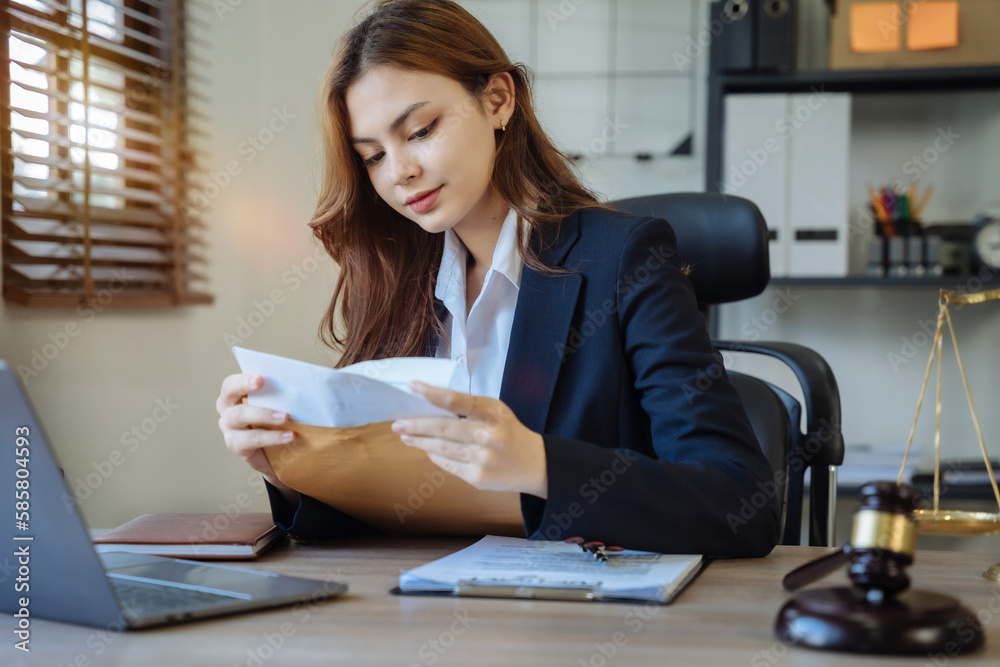 Lawyer woman working with paperwork on his desk in office workplace for consultant lawyer in office. Lawyer woman working with paperwork on his desk in office workplace for consultant lawyer in office.