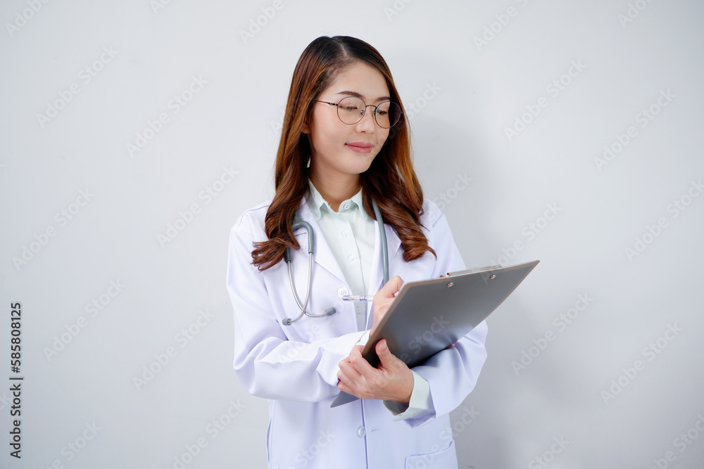 Smiling Asian female doctor holding clipboard medical concept. Smiling Asian female doctor holding clipboard medical concept.