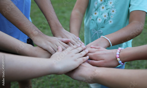 Group of friends with their hands joined. Teamwork. Friendship. Family. Union. Child's play. Preteen friends. friendship pact. group game. Stack of hands showing unity and teamwork. © Acento Creativo