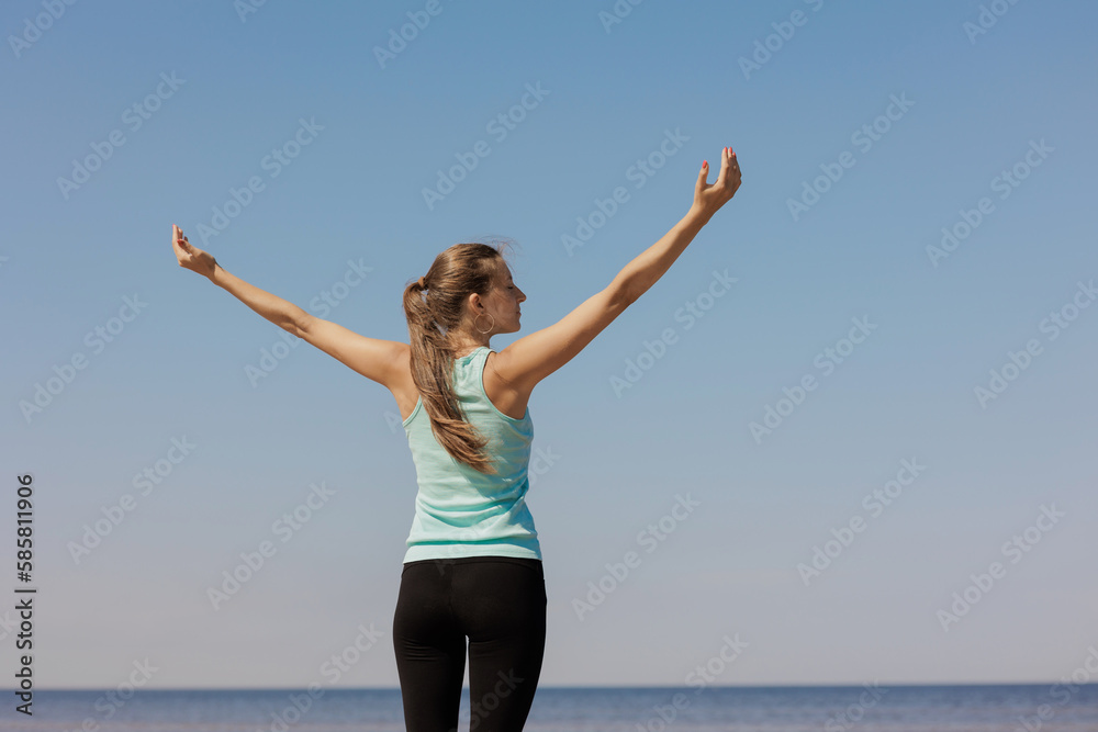 yoga and freedom, sporty woman does warm-up on seashore in morning with hands to sides. fitness millennial female trains, asana breathing practice, healthy lifestyle, love for your body, mental and yoga and freedom, sporty woman does warm-up on seashore in morning with hands to sides. fitness millennial female trains, asana breathing practice, healthy lifestyle, love for your body, mental and