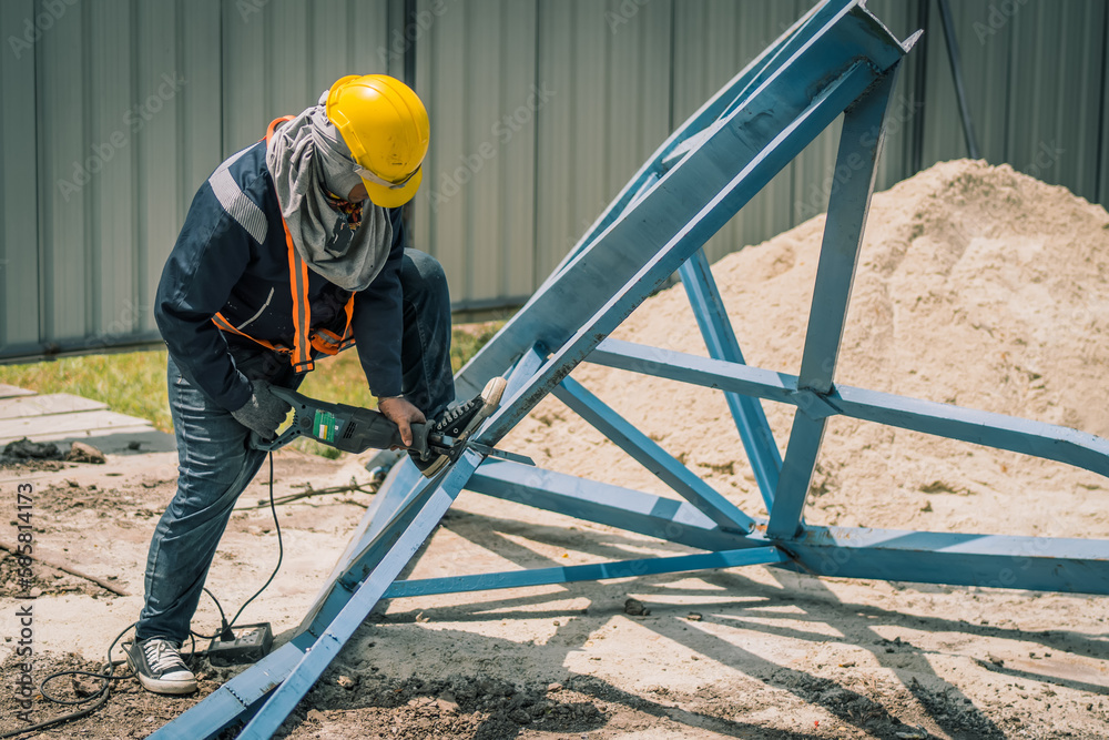 worker to cutting steel in construction site with Reciprocating saw or recip saw, saw used in construction and demolition work without creating any sparks.