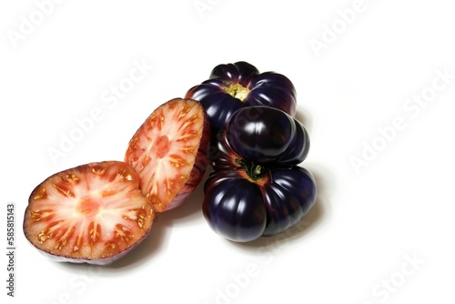 New genetic hybrid tomato variety, a blue tomato cut in half isolated on white background photo