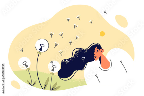 Teenager girl walking in spring meadow blowing dandelions enjoy fresh air and warm weather