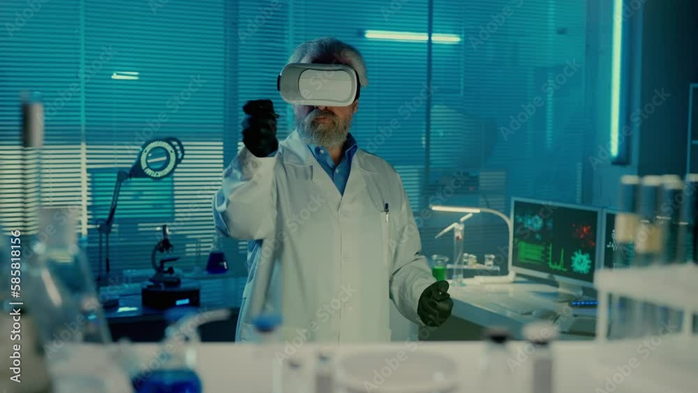 An elderly male doctor in a virtual reality headset controls the image using controllers. Male scientist in a white medical gown in a laboratory with blue light.