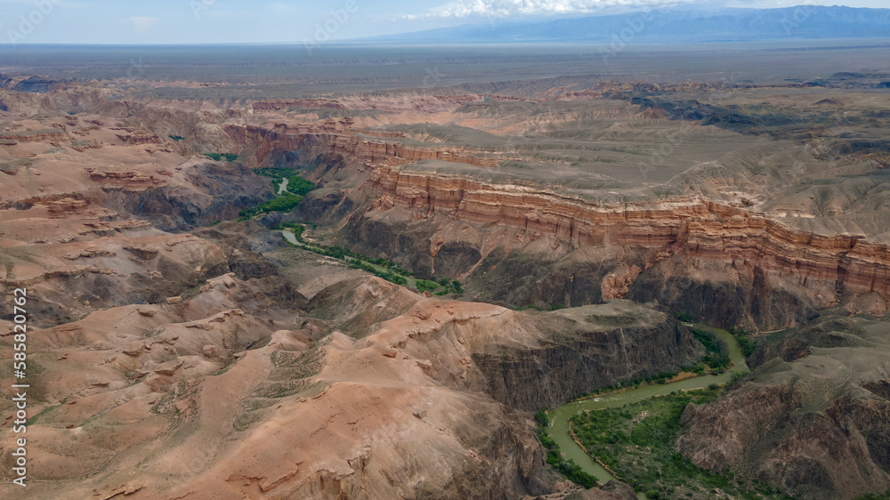 A meandering river in the gorge of a large canyon