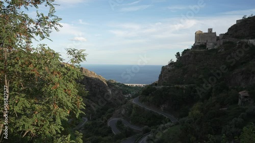 Chiesa di San Nicolo overlooking the Mediterranean Sea in Savoca at sunset, Savoca, Sicily, Italy, Mediterranean, Europe photo