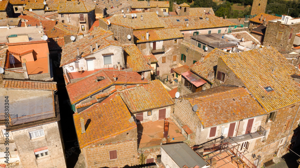 Aerial view of the houses in the historic center of Sutri, near Viterbo and Rome, Italy. All buildings have traditional red tiled roofs in the old town.