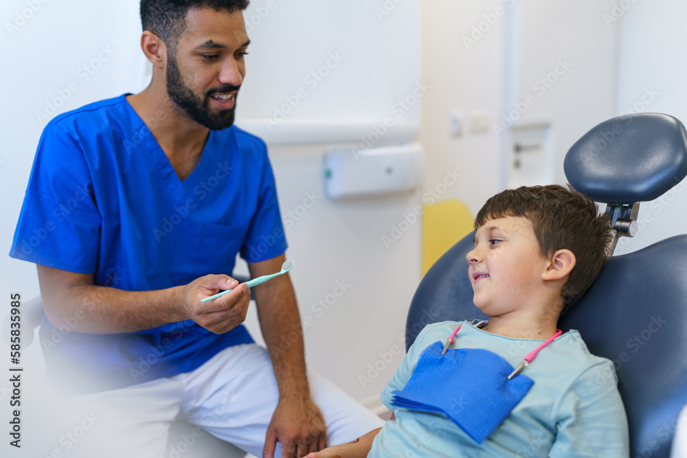 Liitle boy sitting on a dentists chair during dentist examination. Liitle boy sitting on a dentists chair during dentist examination.
