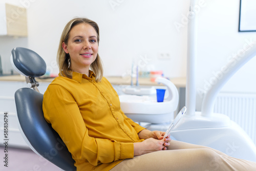 Portrait of young woman in dentist chair.