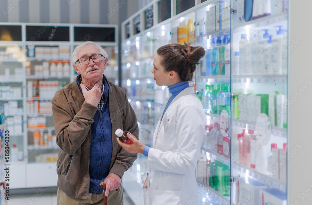 Young pharmacist helping senior man to choos medication.