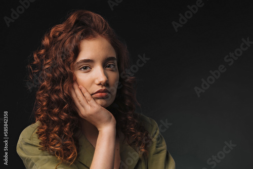Portrait of young bored girl in studio.