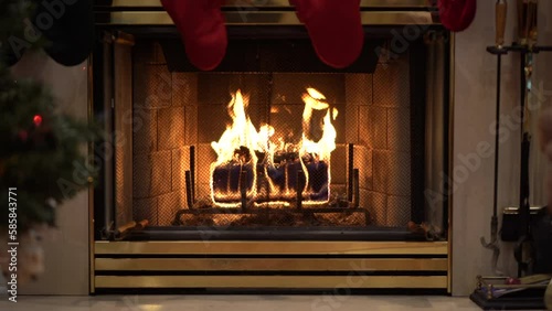 Cozy Fireplace with wax log with Christmas tree and stockings wide angle