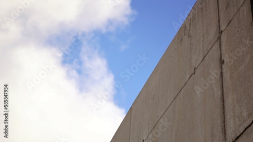 concrete wall against cloudy sky