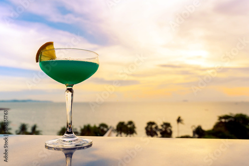 A glass of cocktail on black table against the backdrop of the summer beach. Glasses of red wine on vacation. Wine tasting and relaxation at the resort. Copy space.