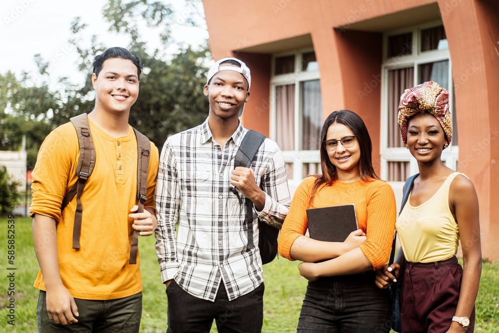 Multi ethnic group of four students smilling looking at camera. Multi ethnic group of four students smilling looking at camera.