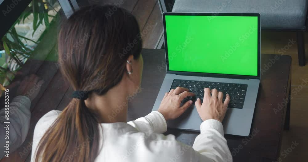 Female freelancer using laptop notebook with green screen press browsing chroma key online typing text message, working remotely on laptop computer in cafe at coffee break Female freelancer using laptop notebook with green screen press browsing chroma key online typing text message, working remotely on laptop computer in cafe at coffee break