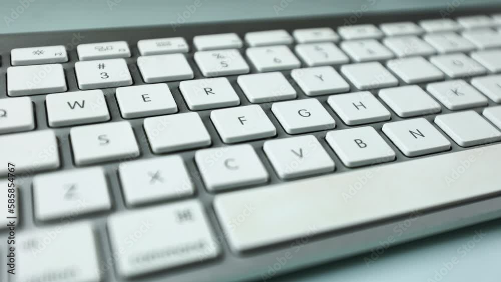Gray keyboard with white buttons. Wireless keyboard. Letters and symbols begin to appear on empty buttons. Computer components. Keyboard on a white background Gray keyboard with white buttons. Wireless keyboard. Letters and symbols begin to appear on empty buttons. Computer components. Keyboard on a white background