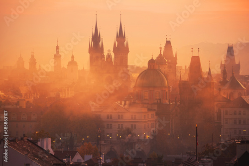 Fog over Prague Towers at beautiful sunrise, view from the Mala Strana , City of a Hundred Spires - Prague, Bohemia, Czech Republic at sunrise