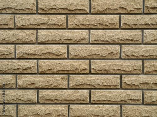 Wall made of beige clinker tiles imitating brickwork. Facing of facades in construction. Brick texture background, wallpaper.    photo