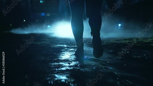 A people walking in the dark through the fog and darkness after the rain