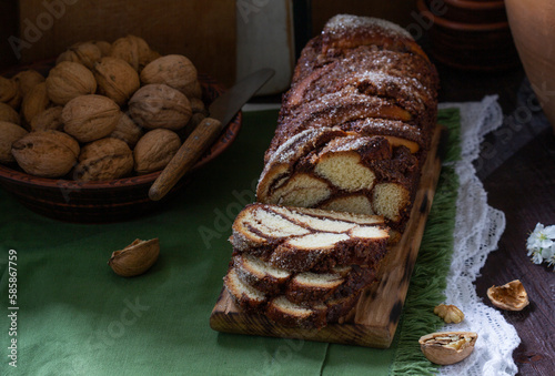Obraz na płótnie Traditional Easter bread with chocolate and nut filling on a wooden background. w salonie
