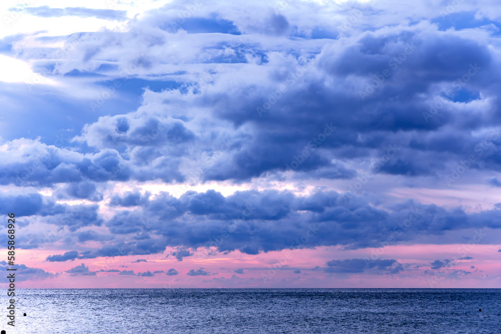 Fototapeta premium Majestic dramatic sunset sky with large and dark rain clouds in evening time over the Andaman Sea in Langkawi island, Malaysia