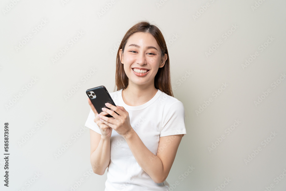 Happy Asian woman holding a smartphone and winning the prize. Happy Asian woman holding a smartphone and winning the prize.