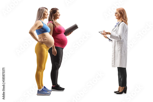 Full length profile shot of two pregnant women talking to a female physician