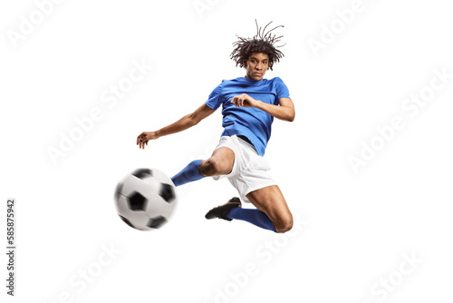 African american football player jumping and kicking a ball