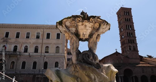 Fountain of the Tritons, Palazzo Pantanella and Basilica of Saint Mary in Cosmedin in the background, Rome, Italy. photo